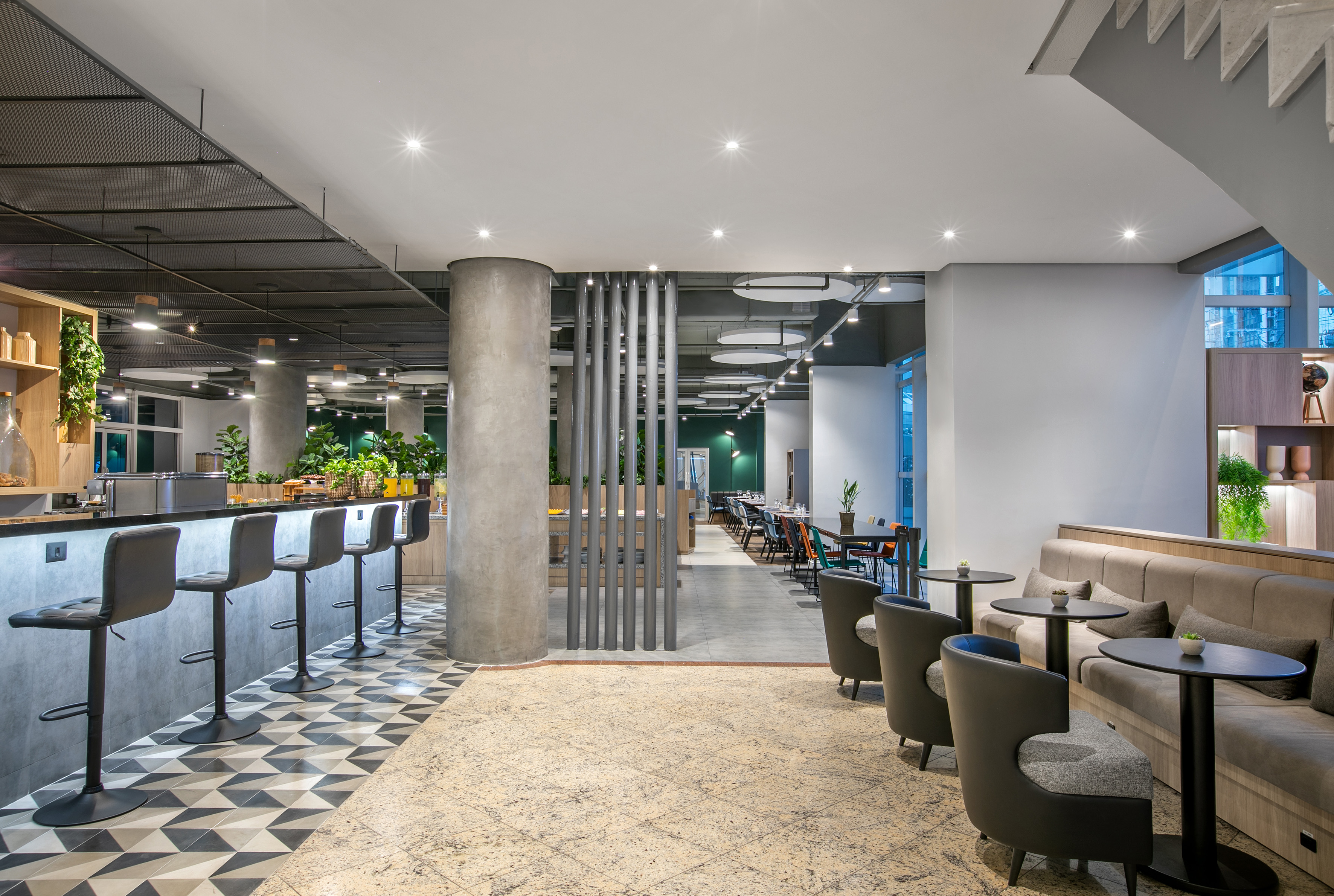 Modern hotel bar and lounge with stylish seating and restaurant dining.