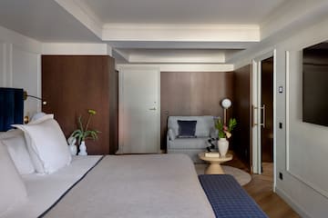 a bedroom with a bed and a couch