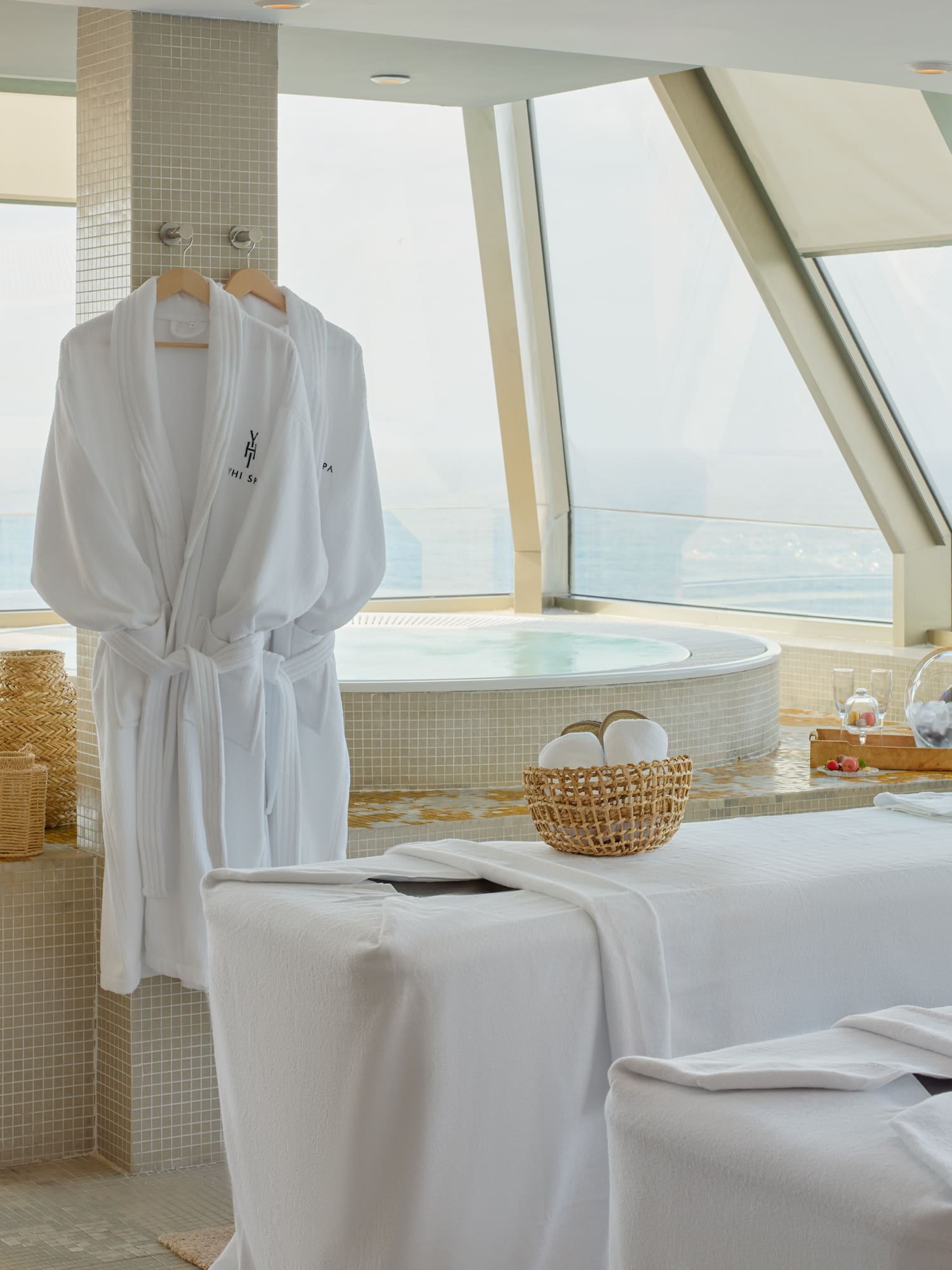 a room with white bathrobes and towels