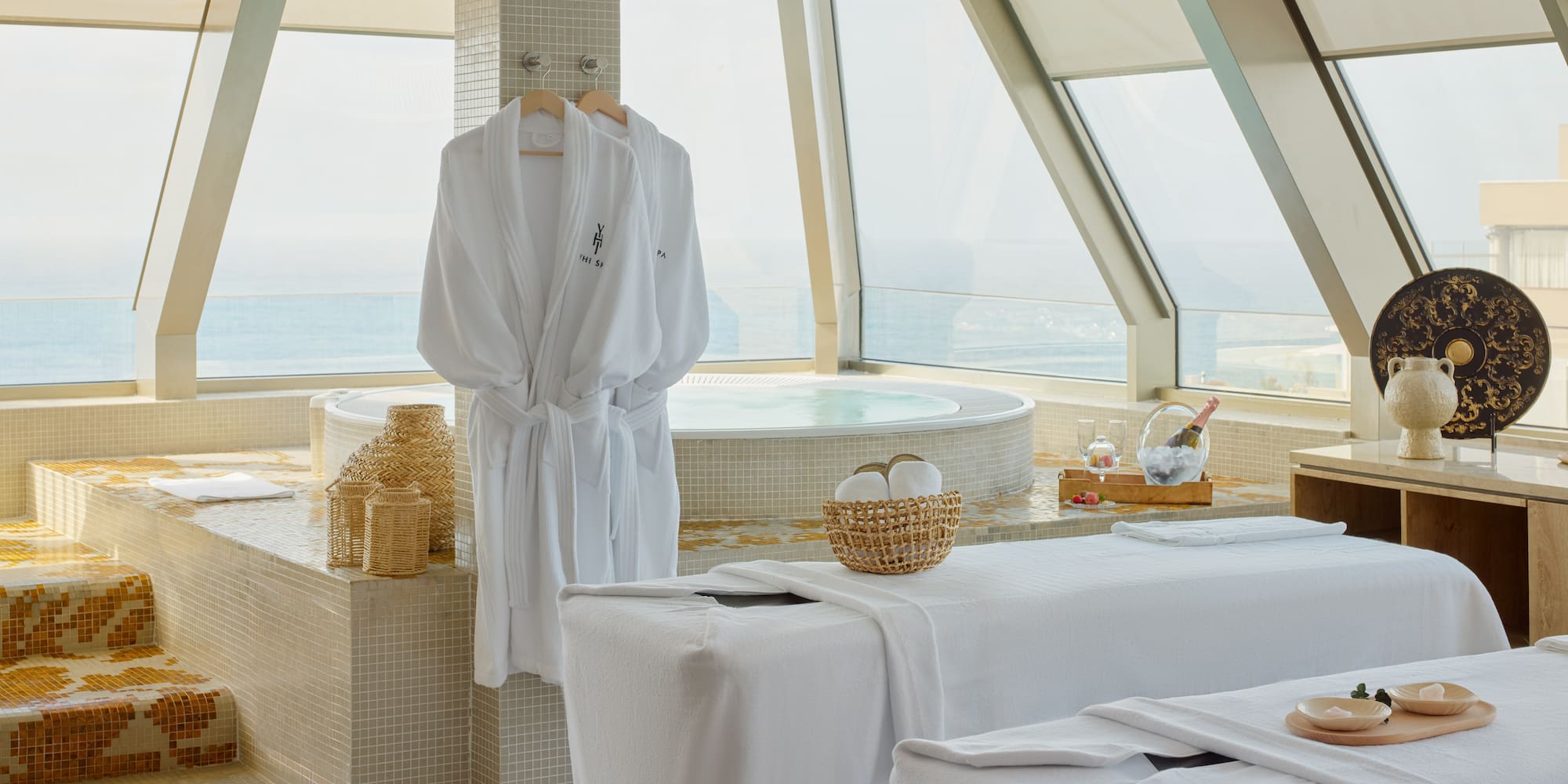 a room with white bathrobes and towels