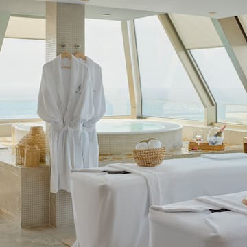 a room with white bathrobes and towels