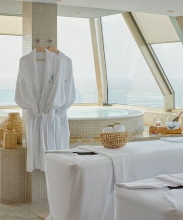 a room with white bathrobes and towels
