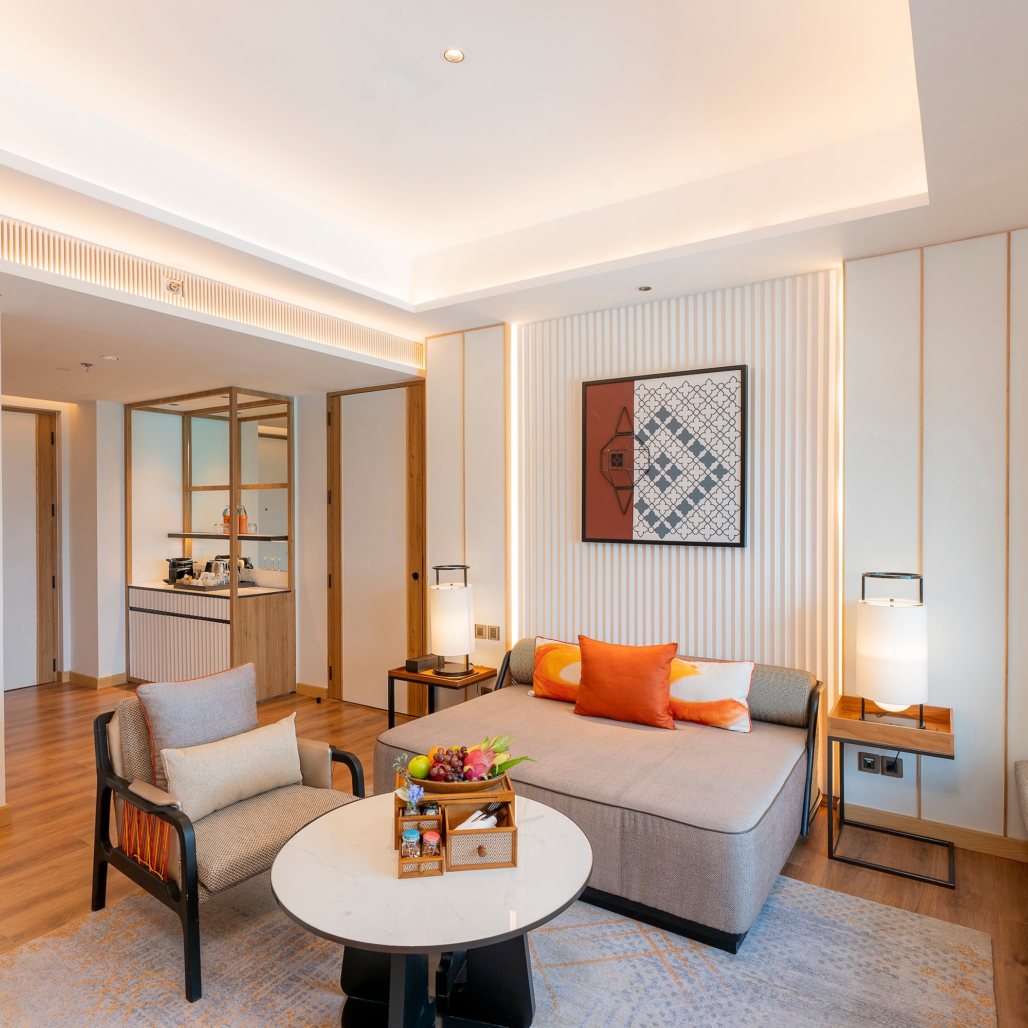 a room with a couch and chairs