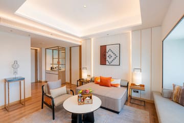a room with a couch and chairs