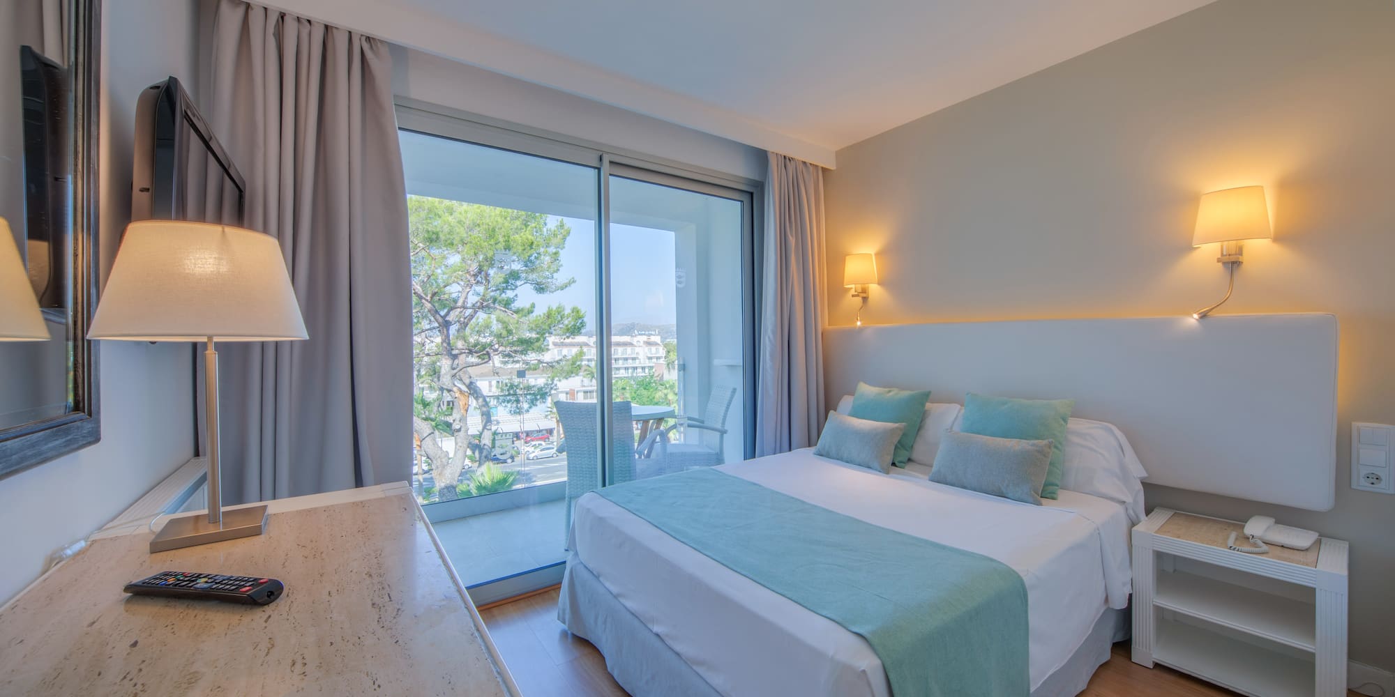 a bedroom with a desk and a bed