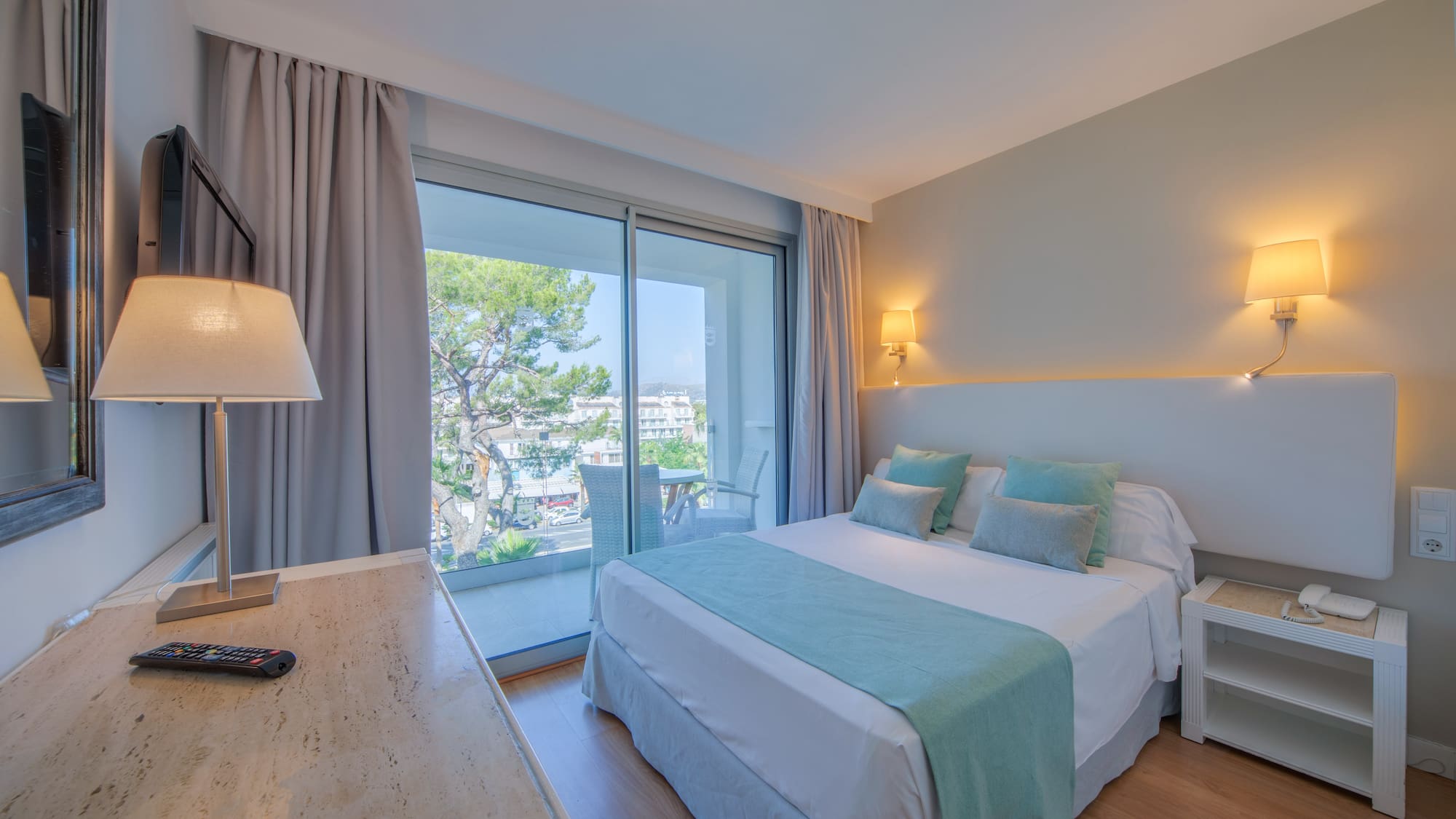 a bedroom with a desk and a bed