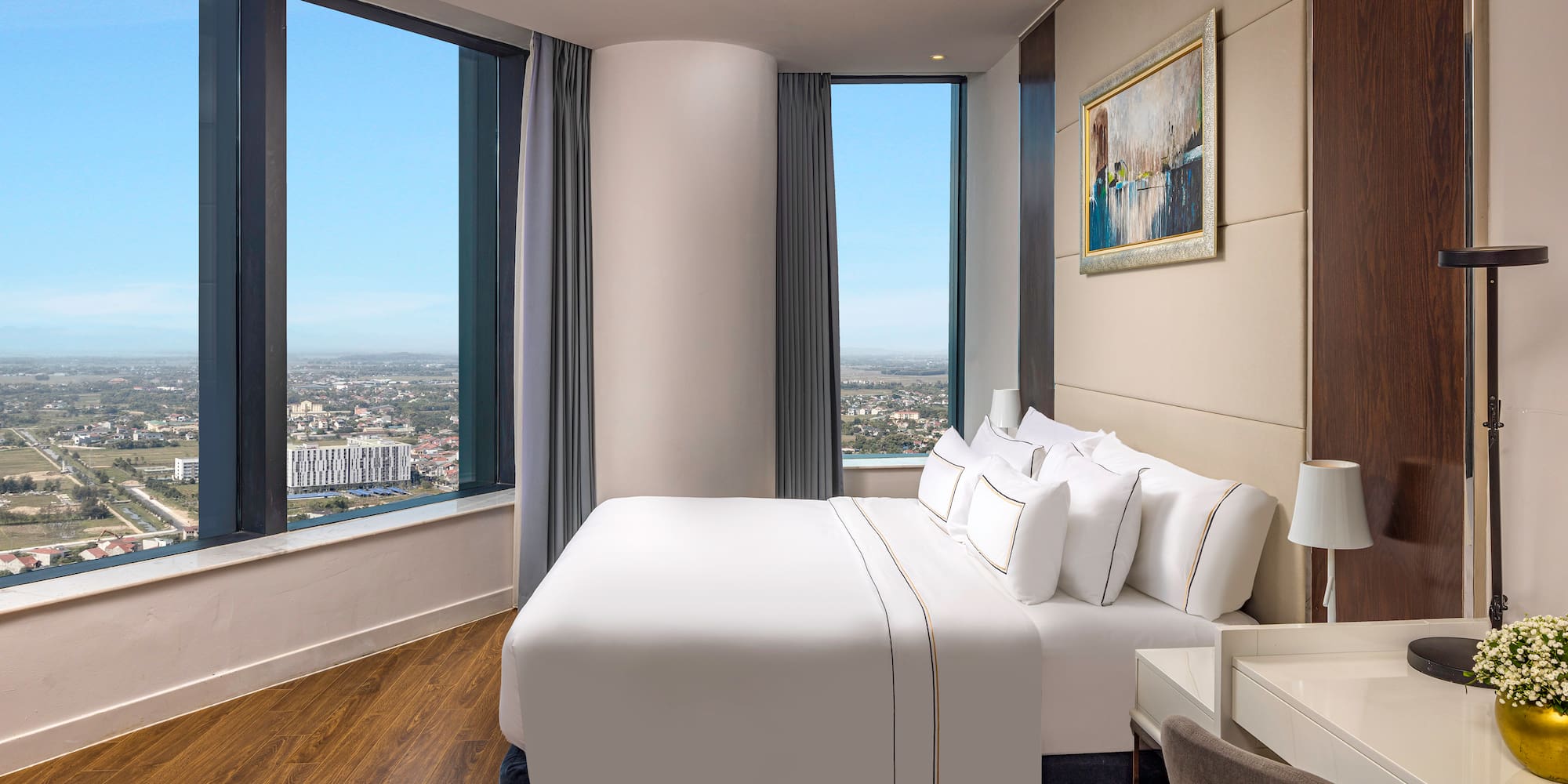 a bedroom with a large window and a large bed