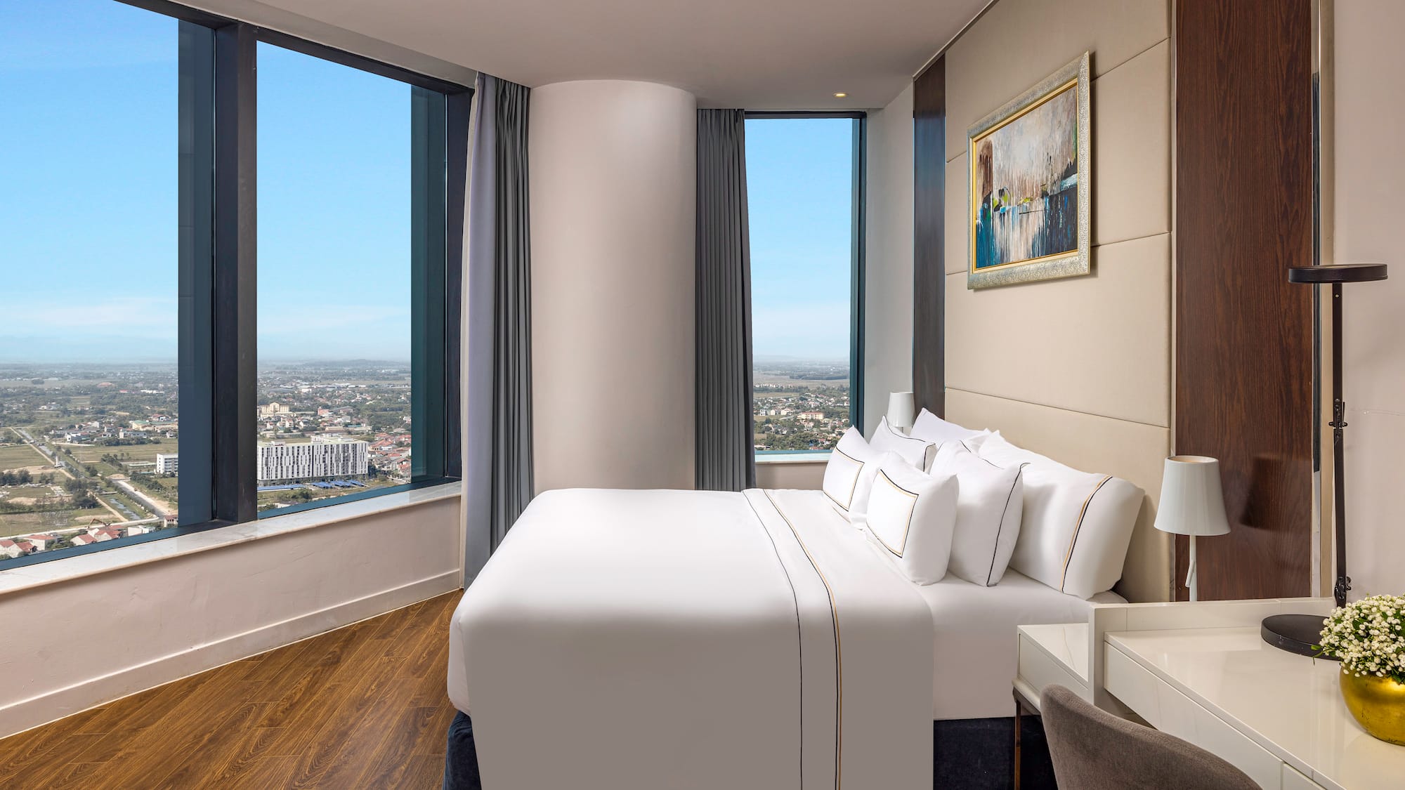 a bedroom with a large window and a large bed