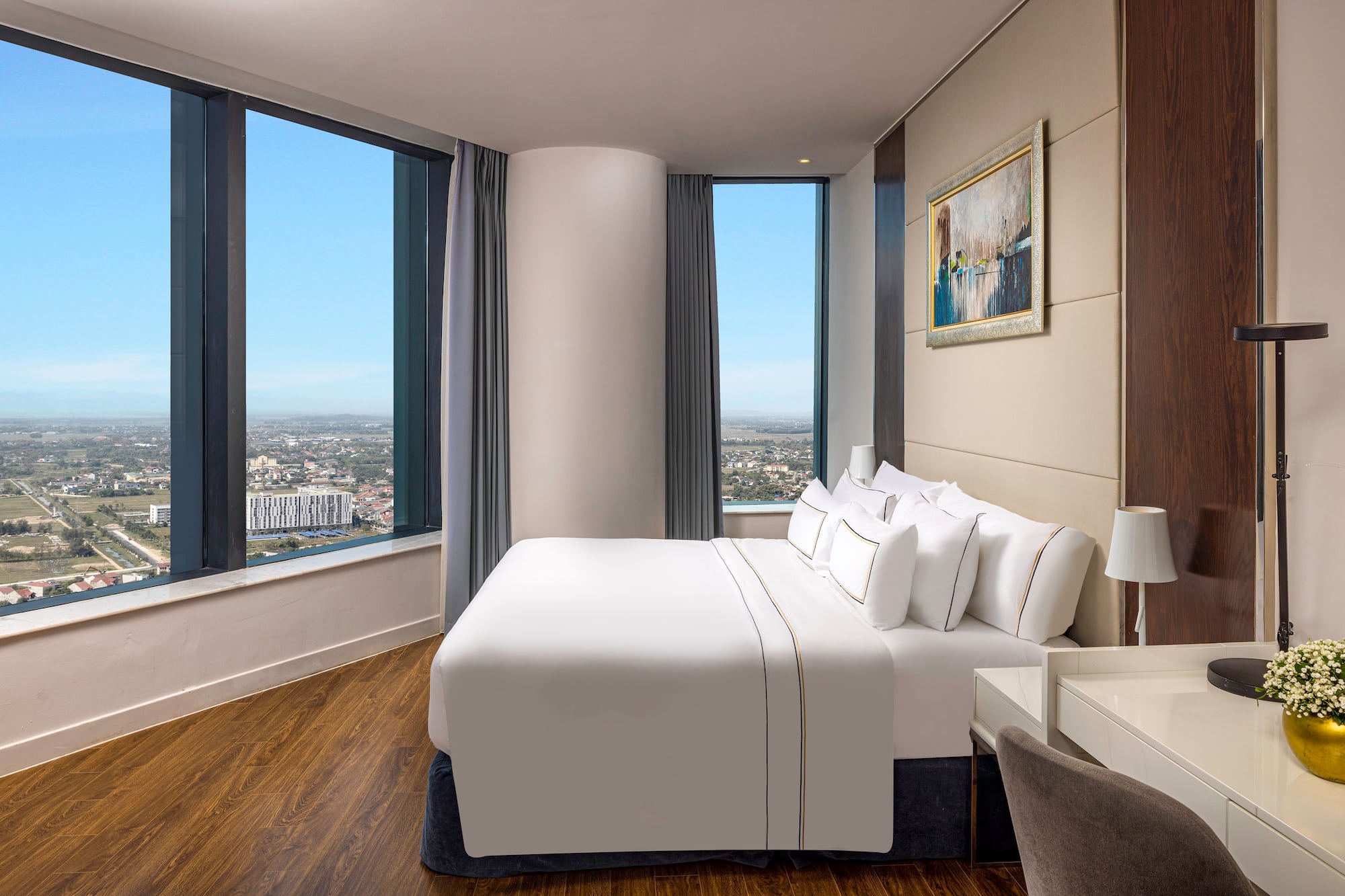 a bedroom with a large window and a large bed