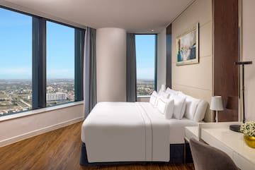 a bedroom with a large window and a large bed