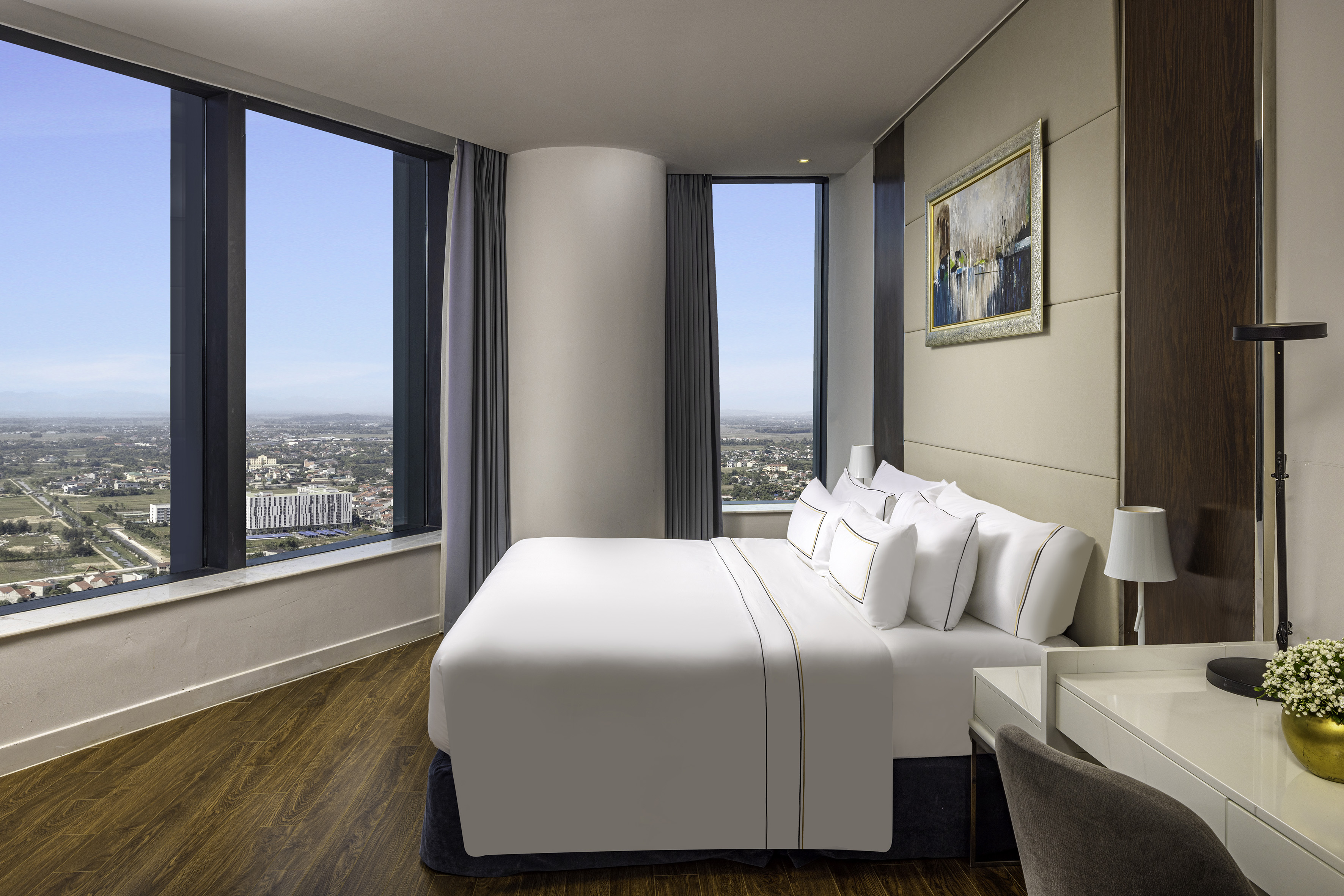 a bedroom with a large window and a large bed