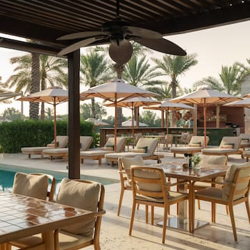 a pool with tables and chairs