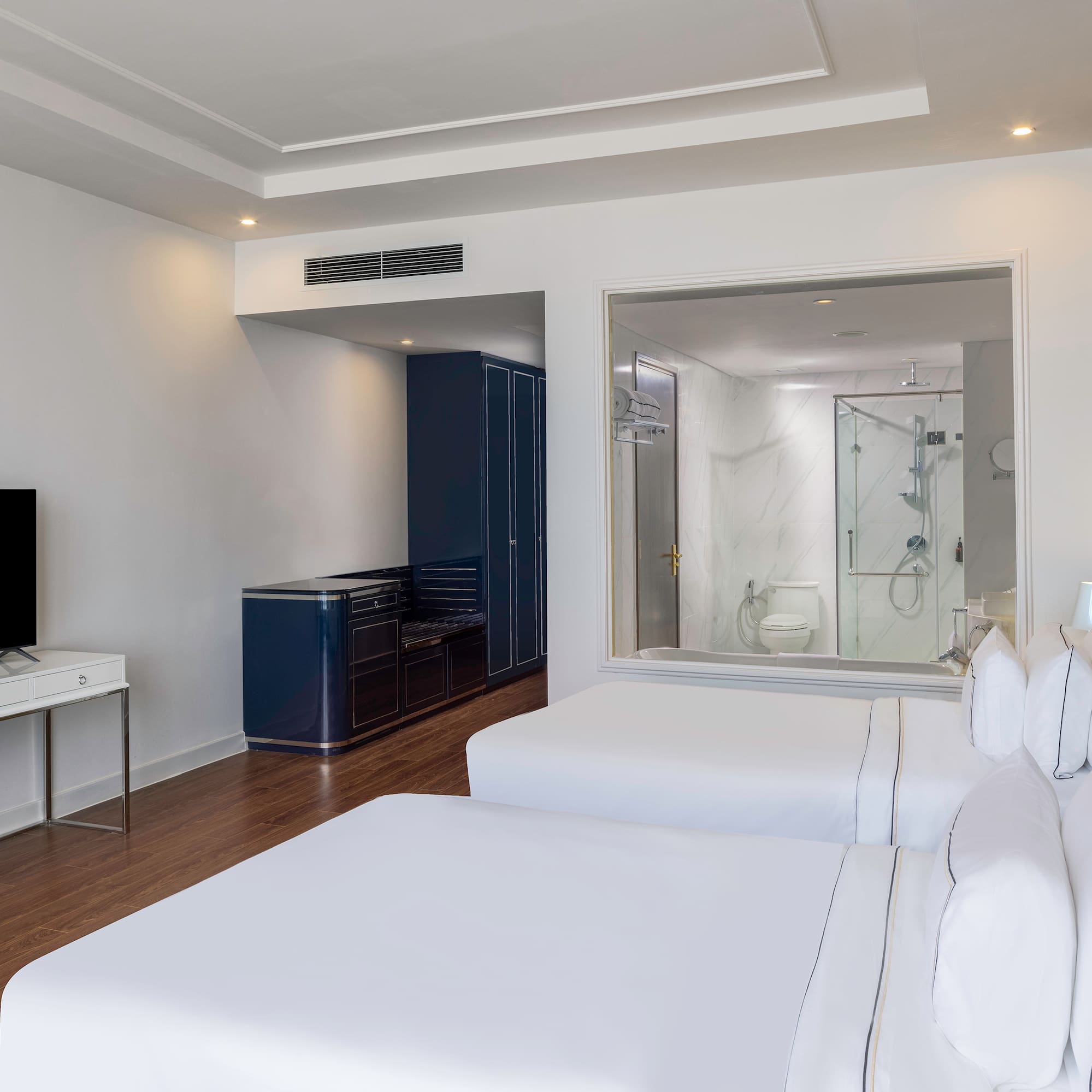 a room with two beds and a tv