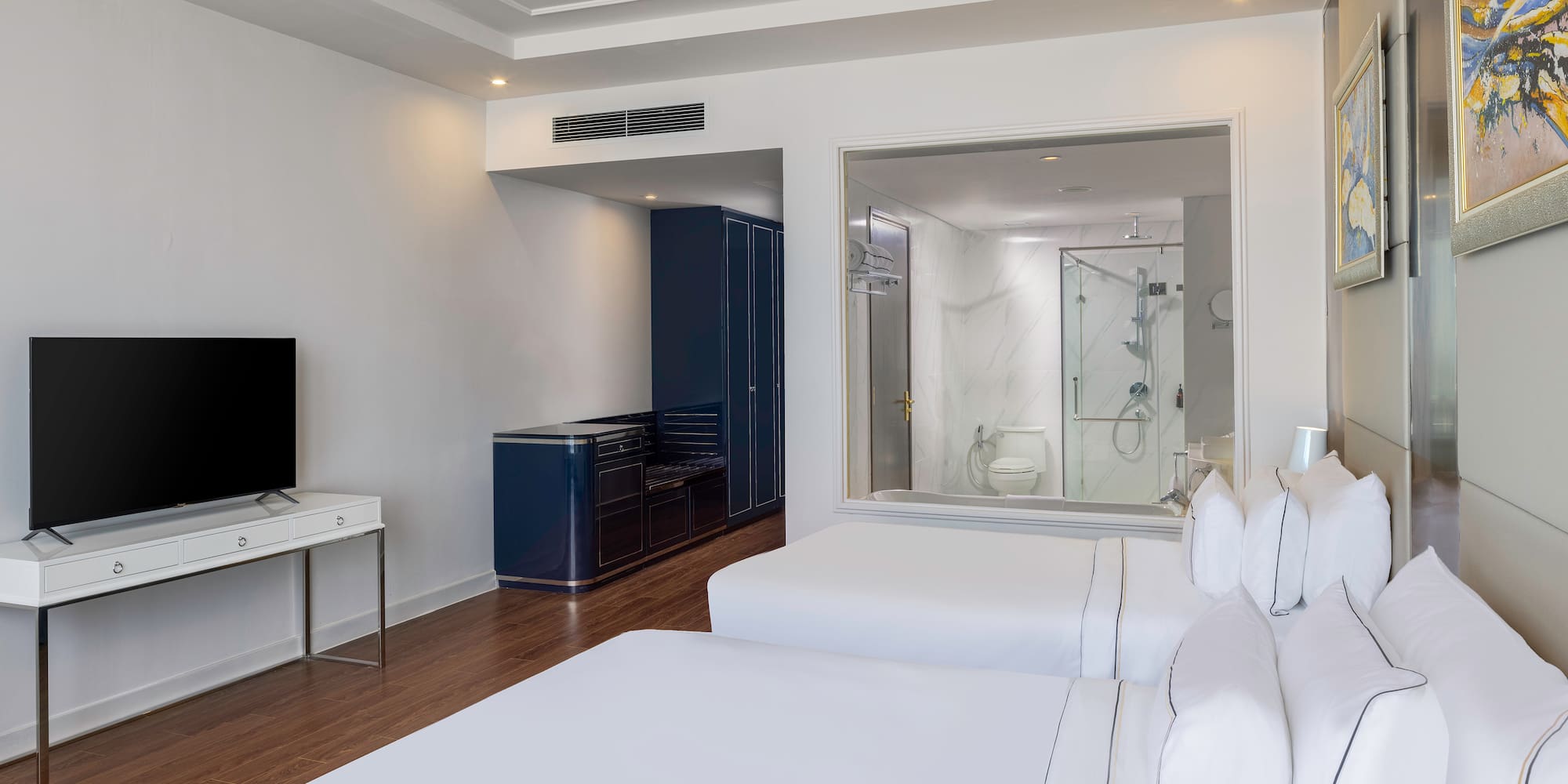 a room with two beds and a tv