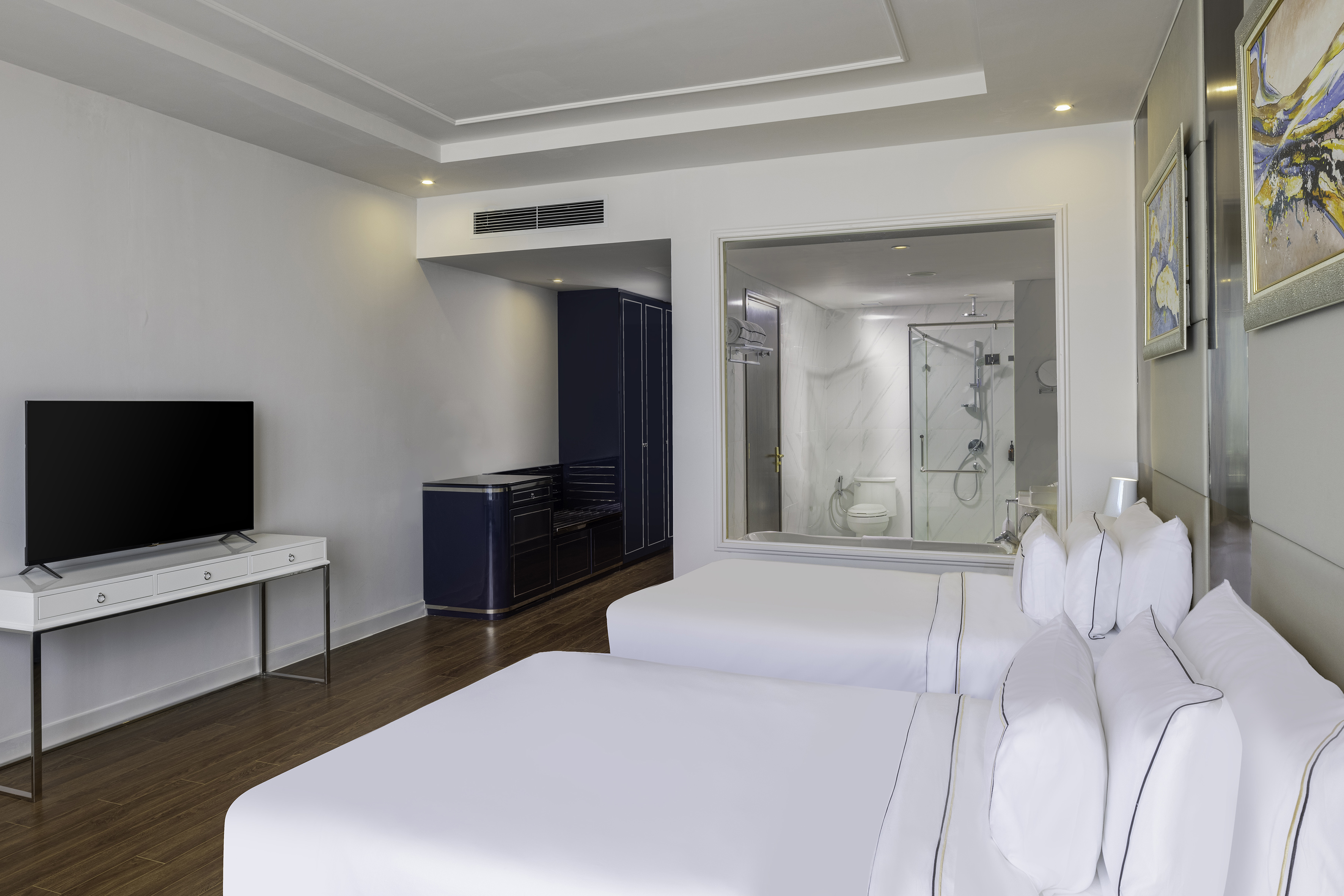 a room with two beds and a tv