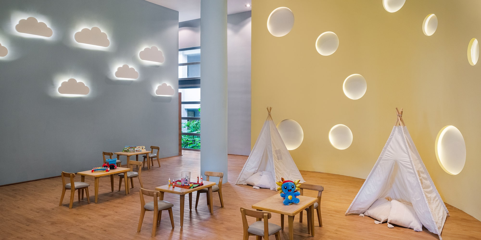 a room with tables and chairs and teepees