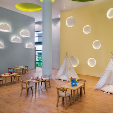 a room with tables and chairs and teepees