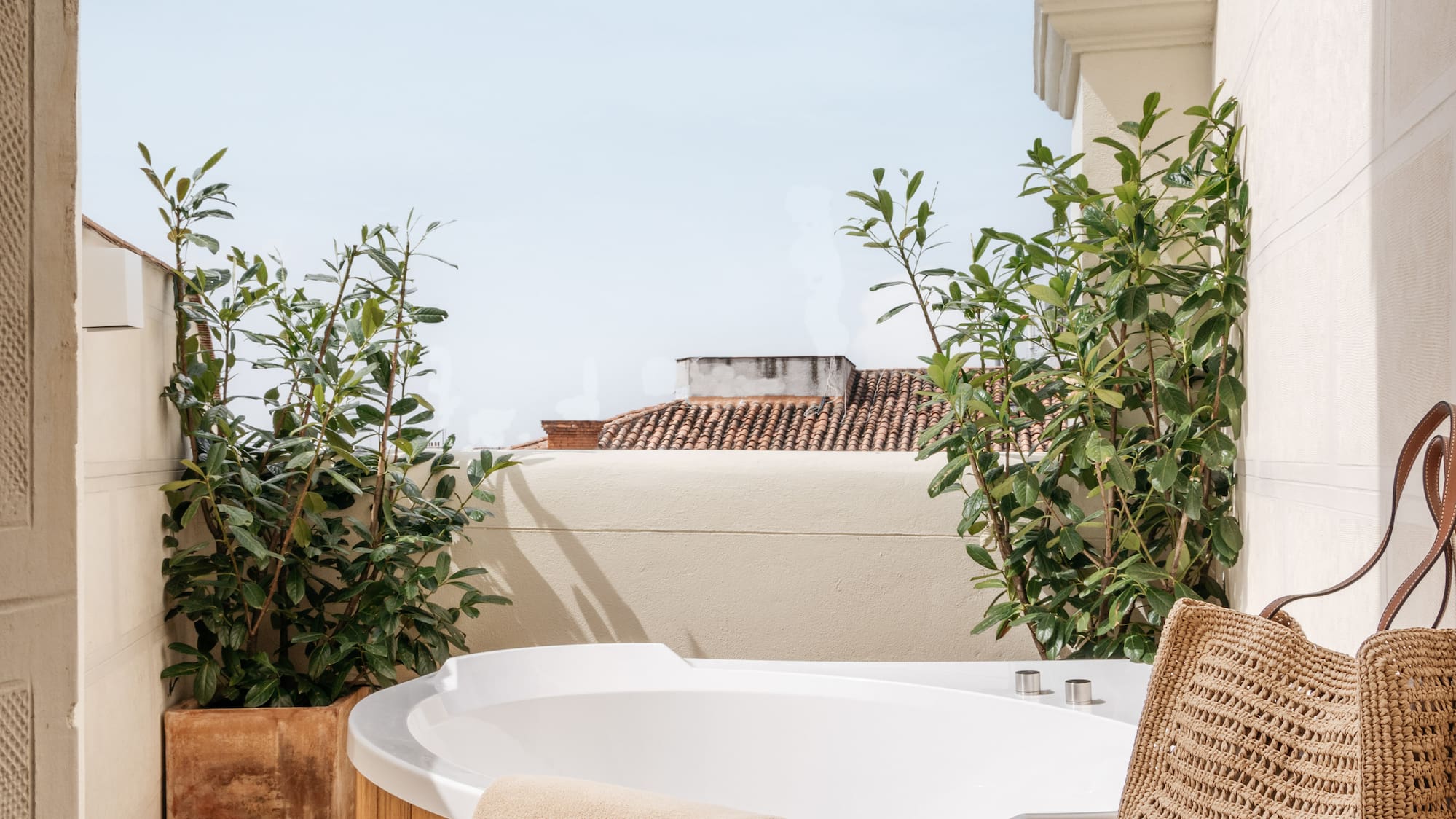 a hot tub with a magazine and a bag on a deck