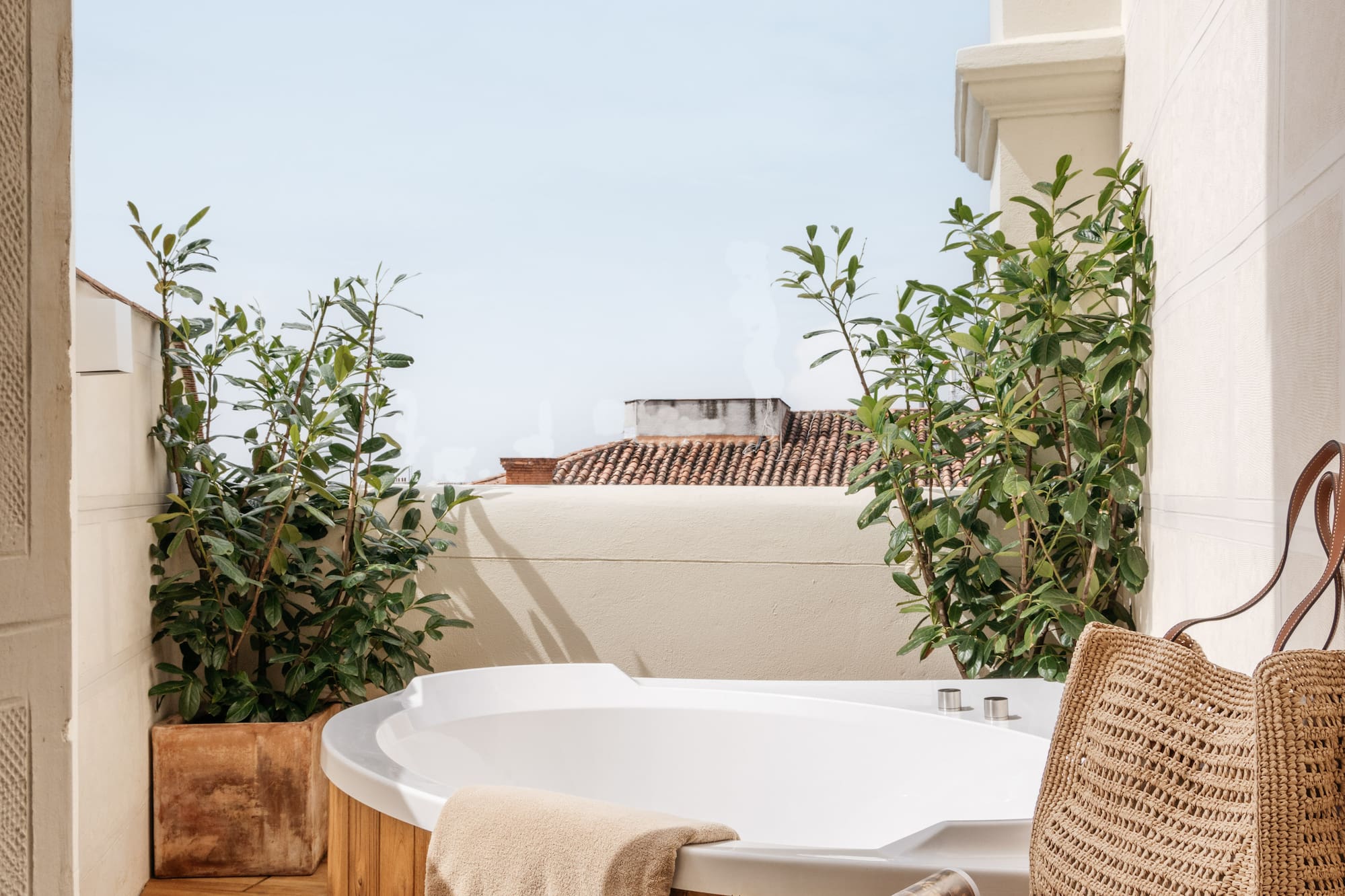 a hot tub with a magazine and a bag on a deck