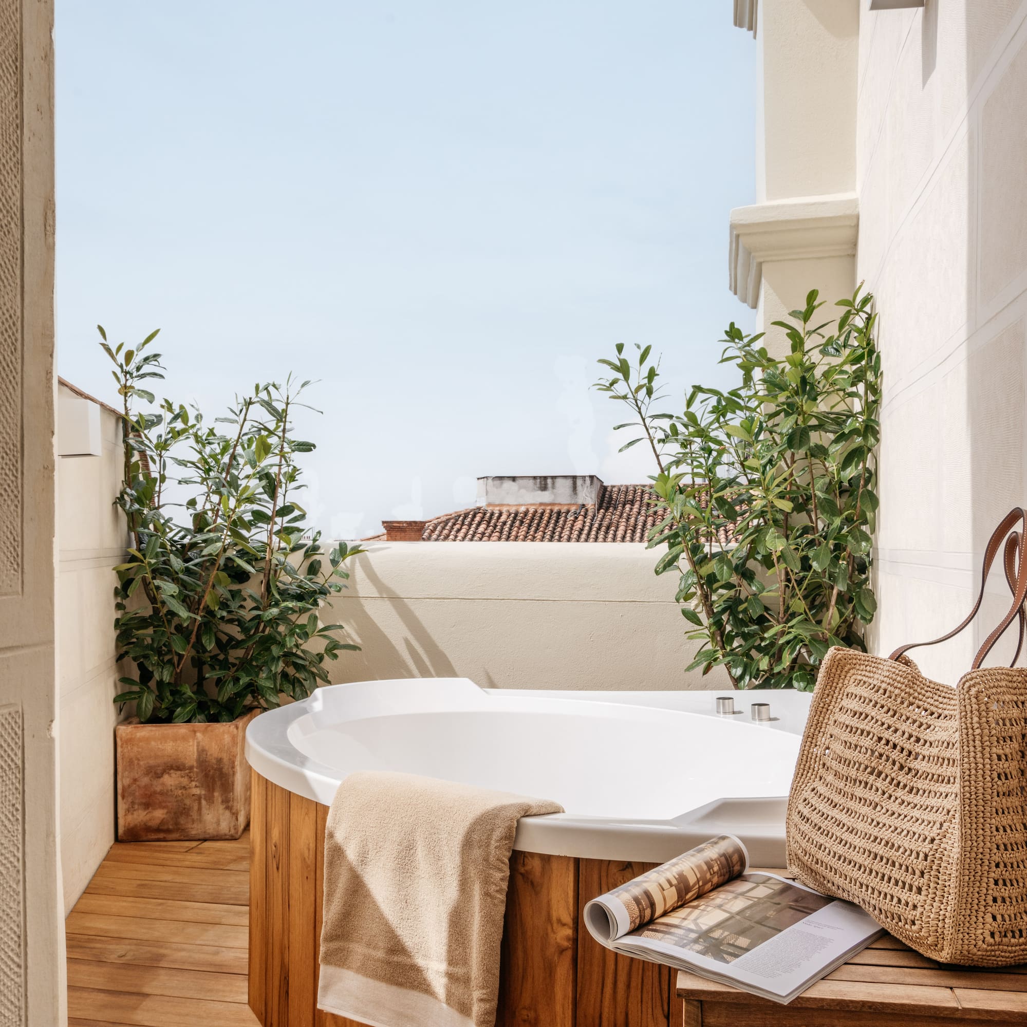 a hot tub with a magazine and a bag on a deck