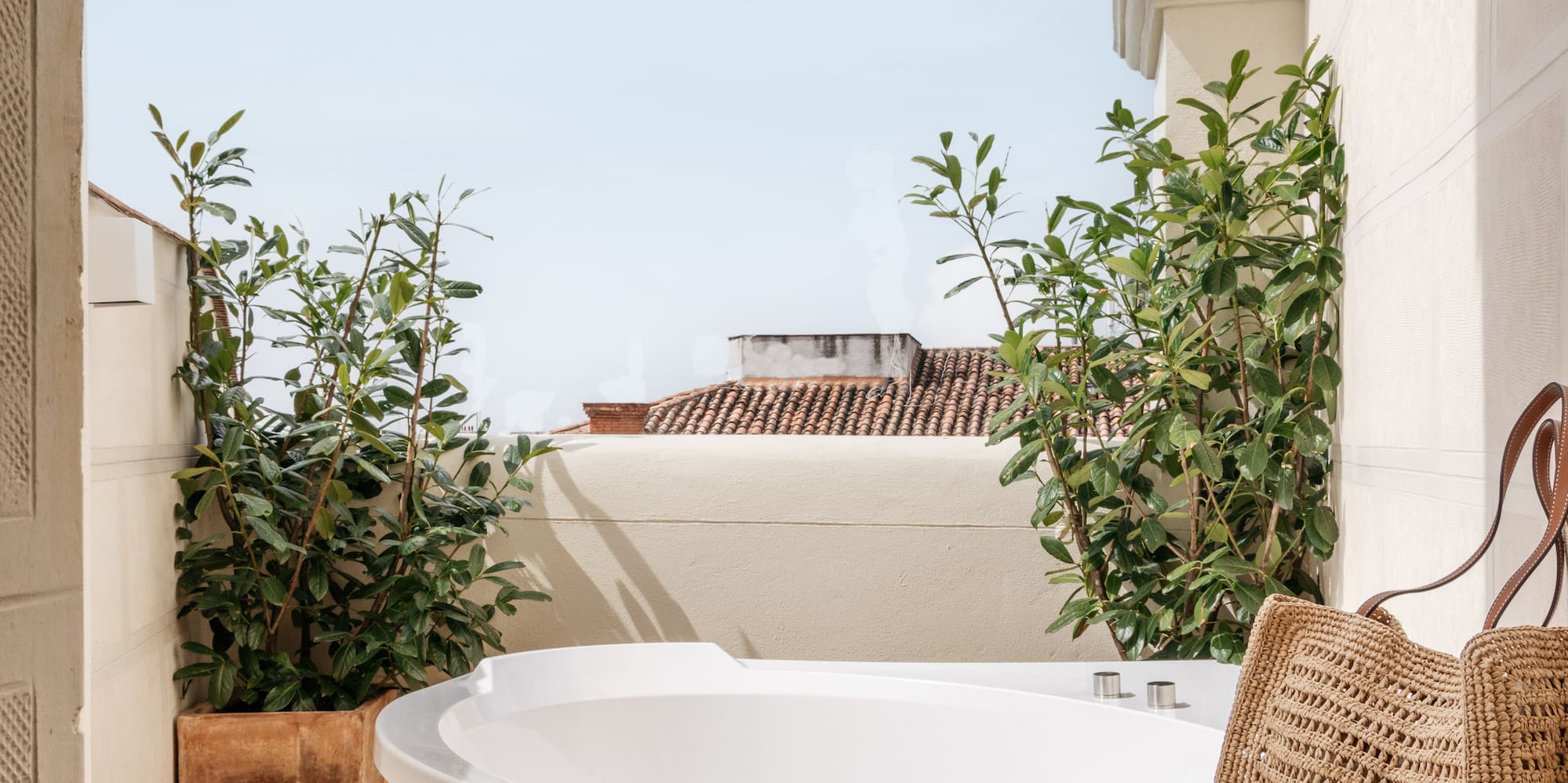 a hot tub with a magazine and a bag on a deck