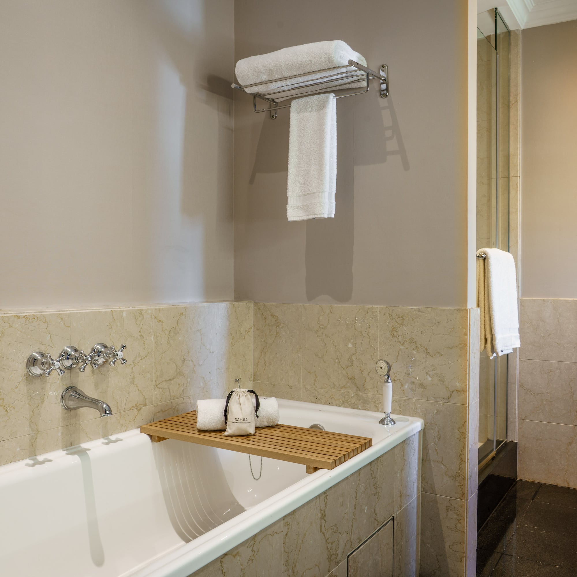 a bathtub with a towel rack and a shower