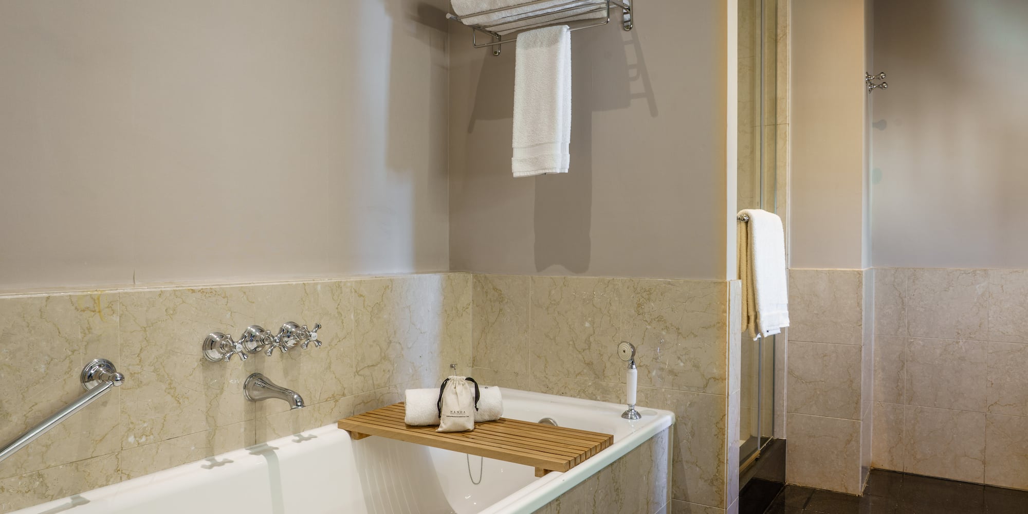 a bathtub with a towel rack and a shower