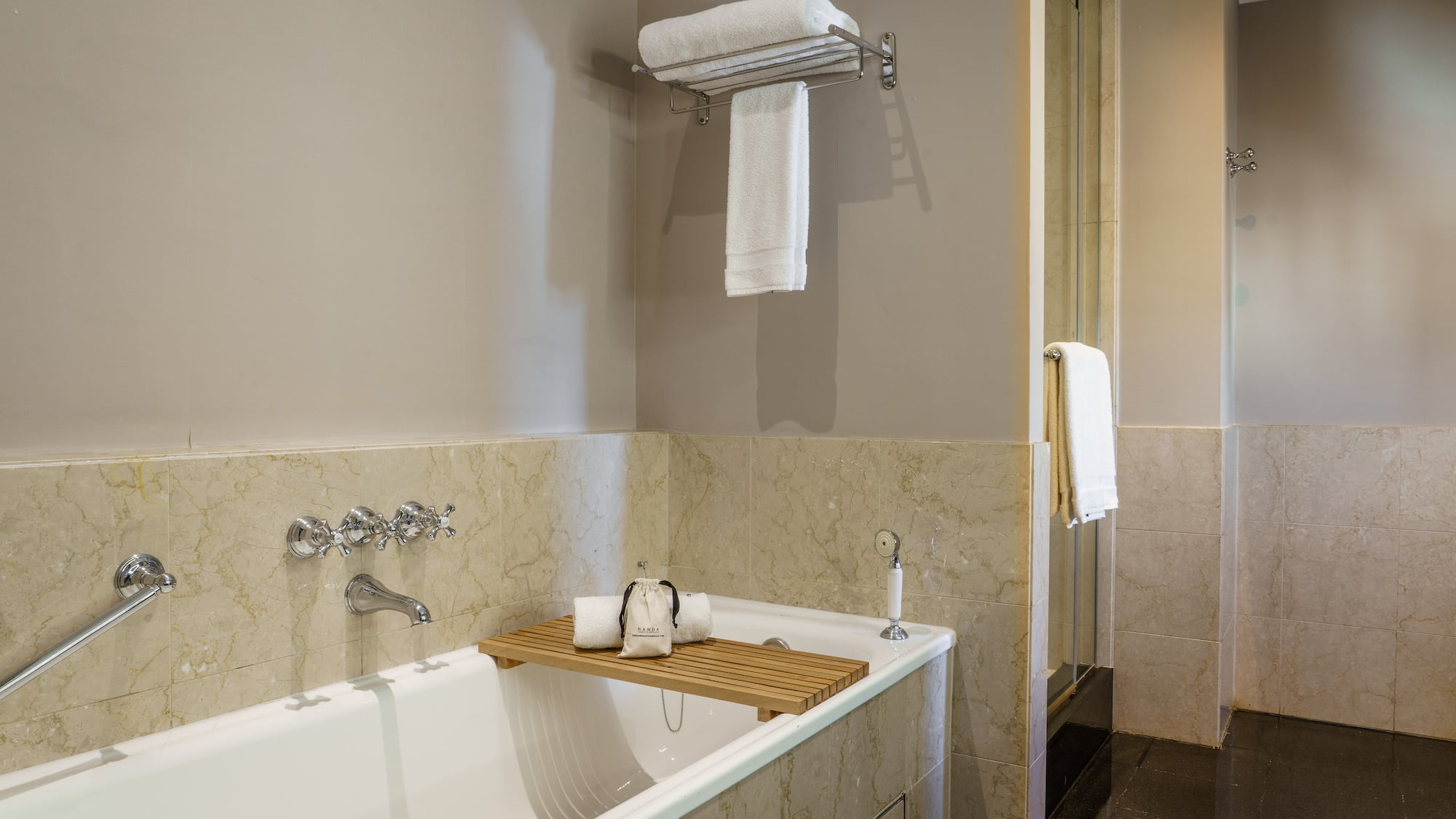 a bathtub with a towel rack and a shower