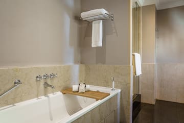 a bathtub with a towel rack and a shower