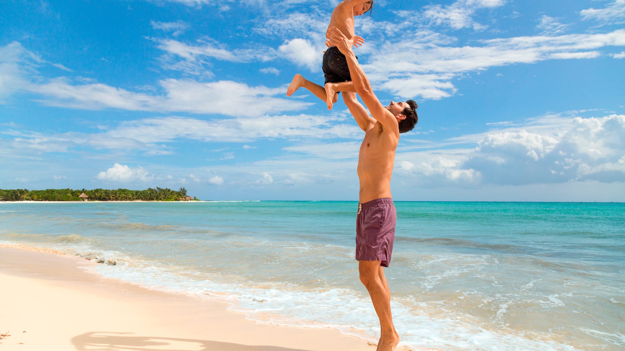 a man and child on a beach