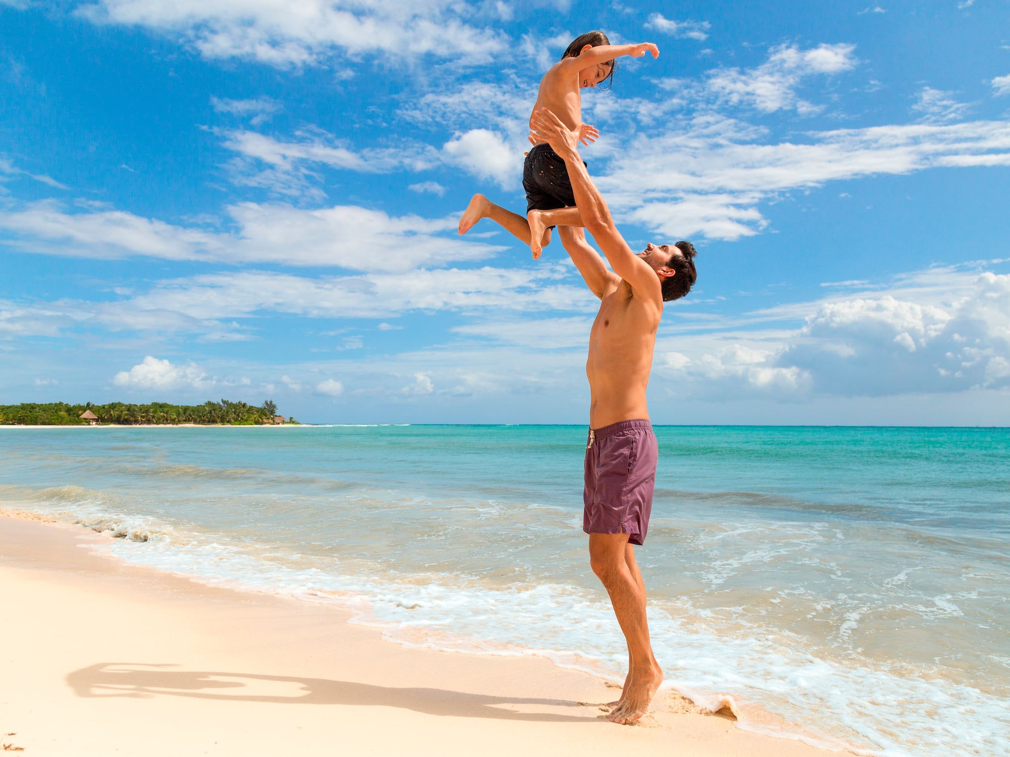a man and child on a beach