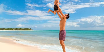 a man and child on a beach