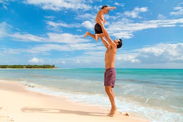 a man and child on a beach