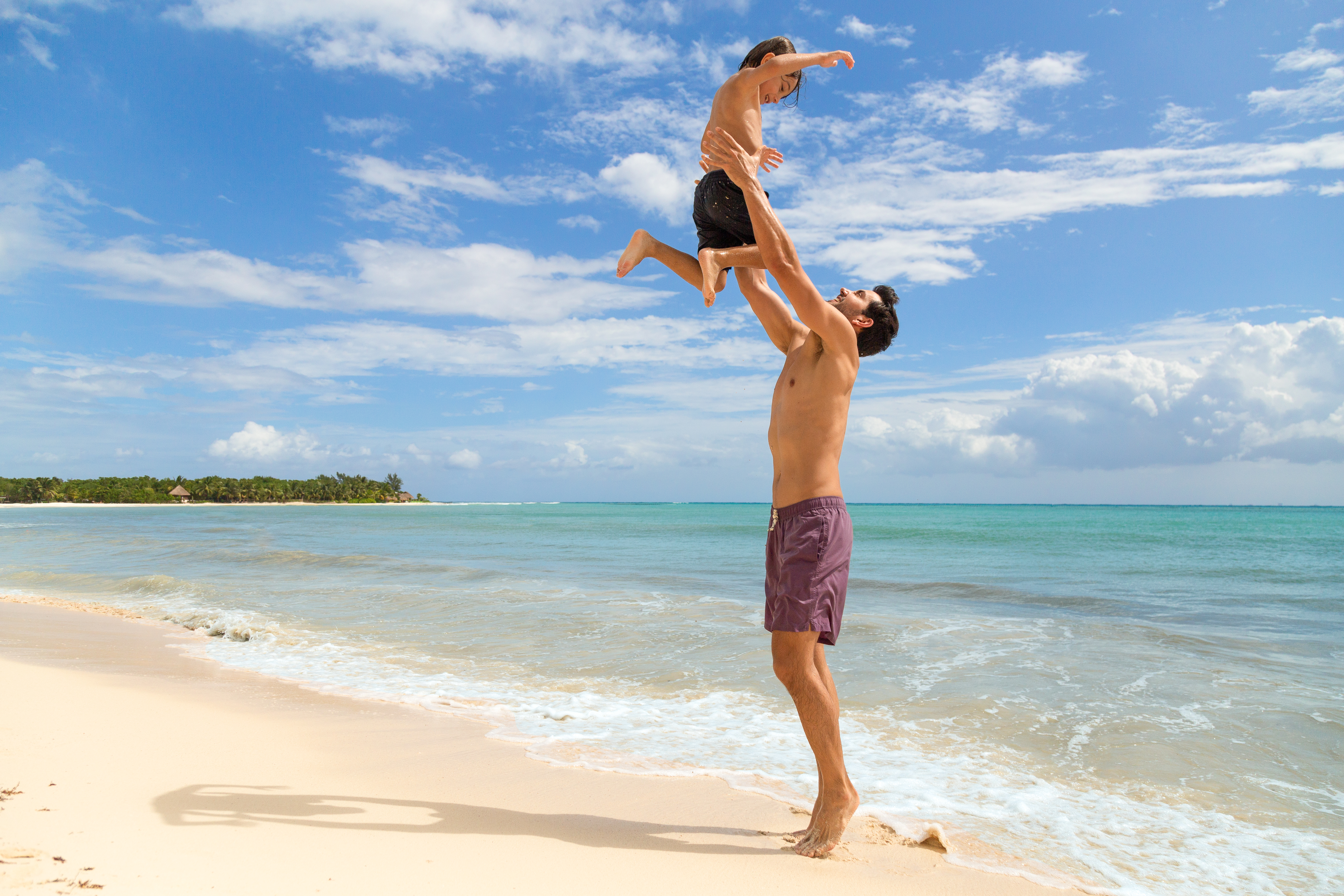 a man and child on a beach