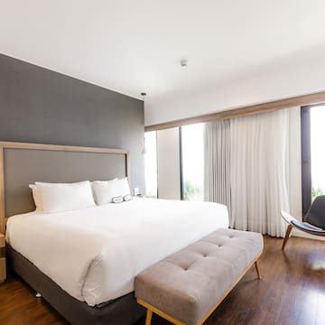 a bedroom with a bed and a chair