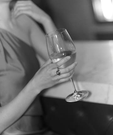 a woman holding a glass of wine