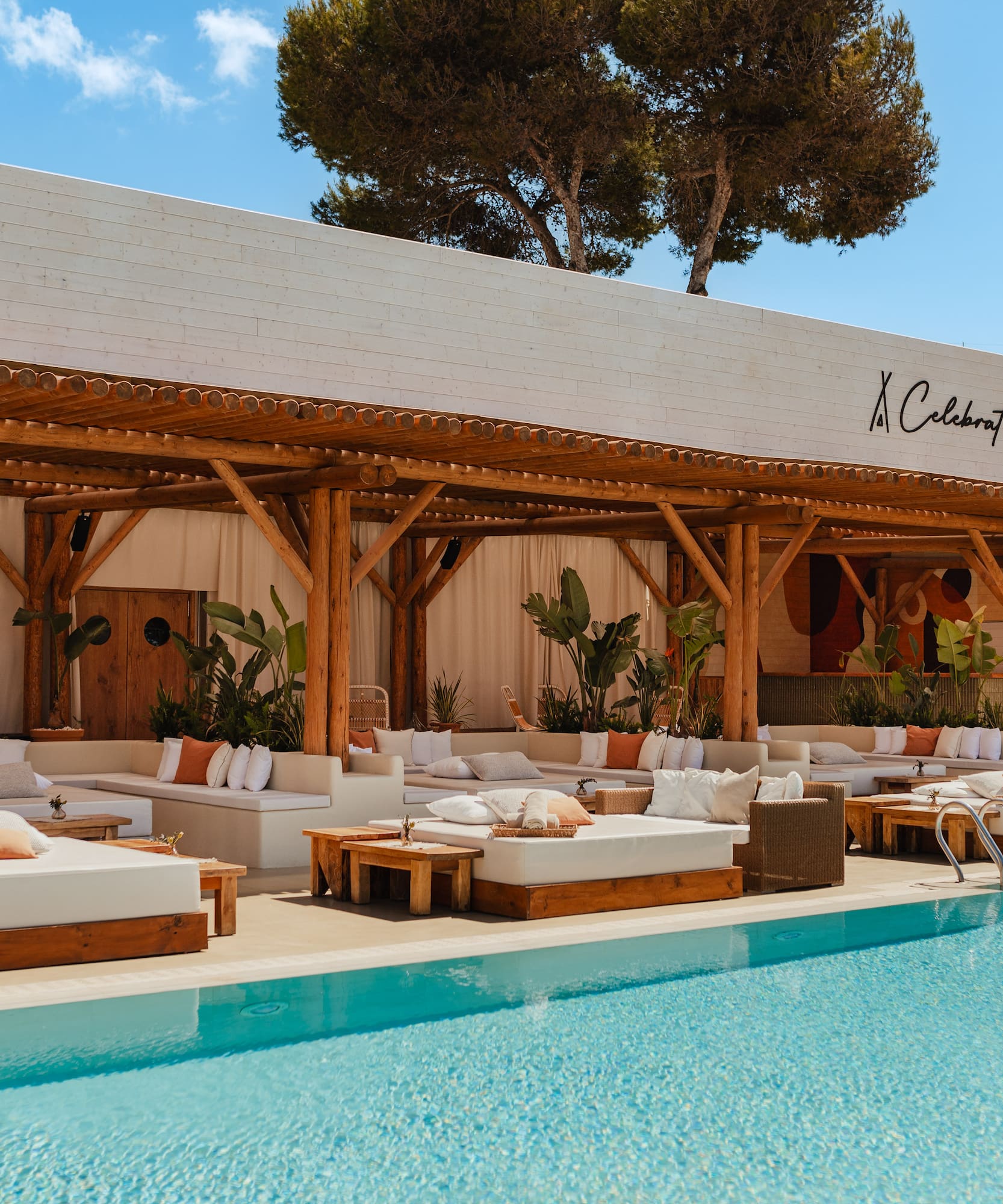 a pool with lounge chairs and a canopy over it