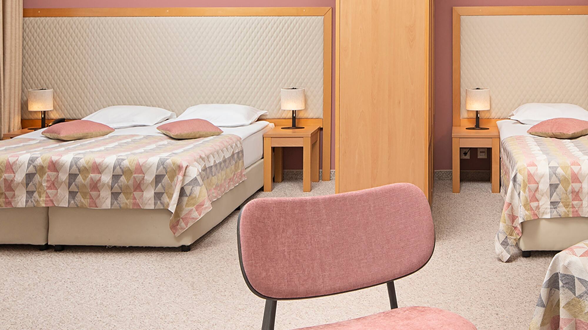 a room with two beds and a table with food