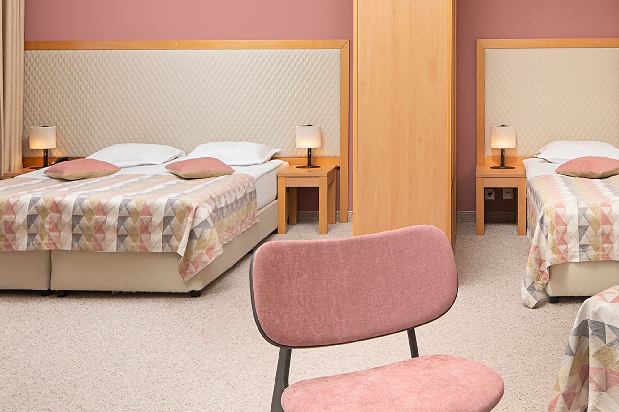 a room with two beds and a table with food