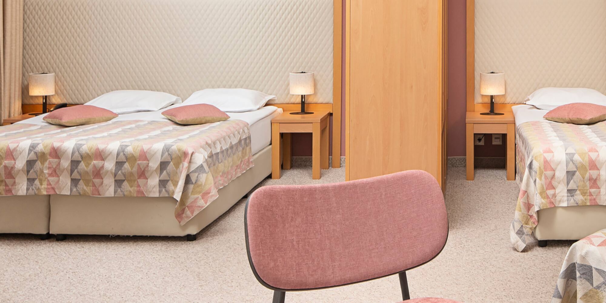 a room with two beds and a table with food