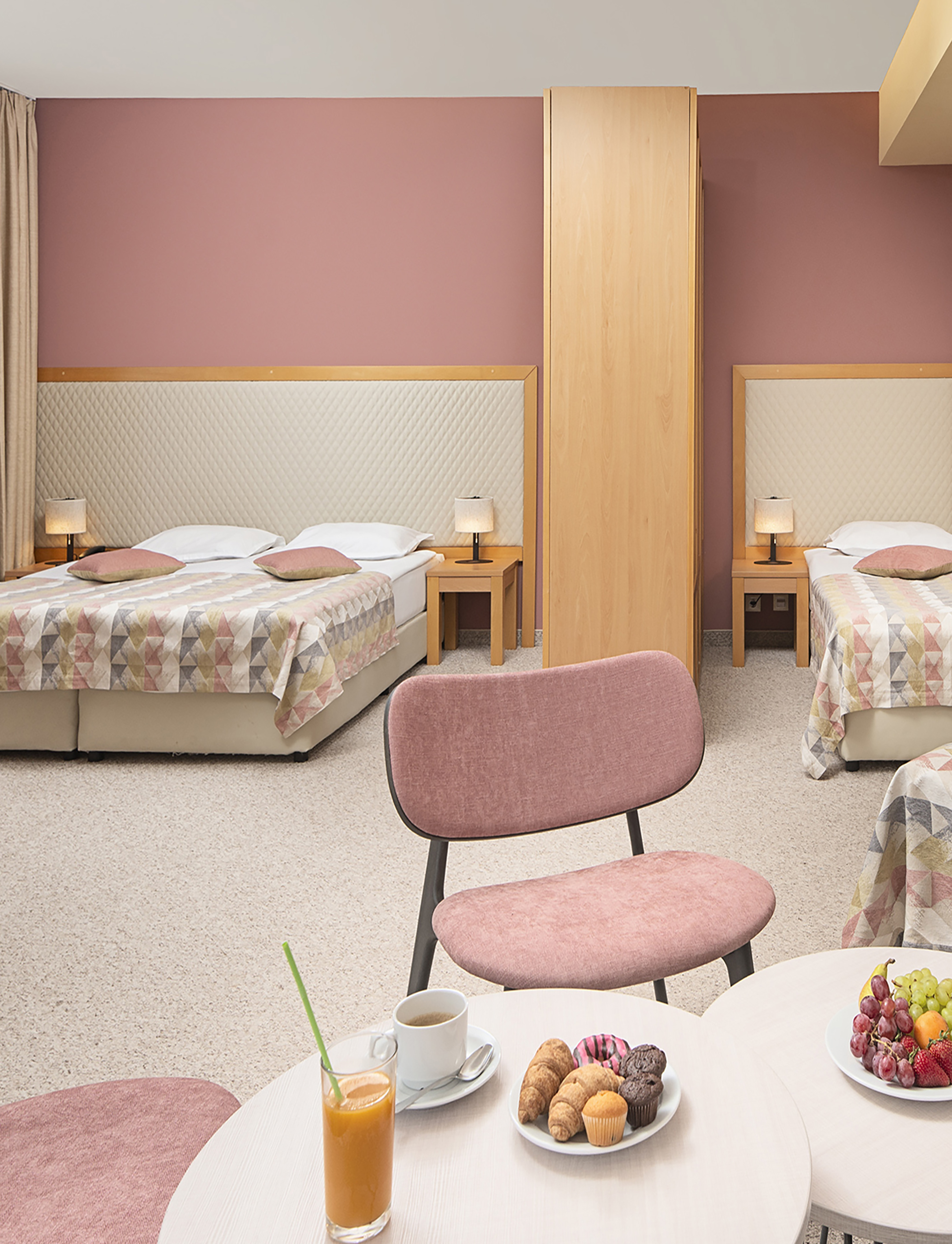 a room with two beds and a table with food