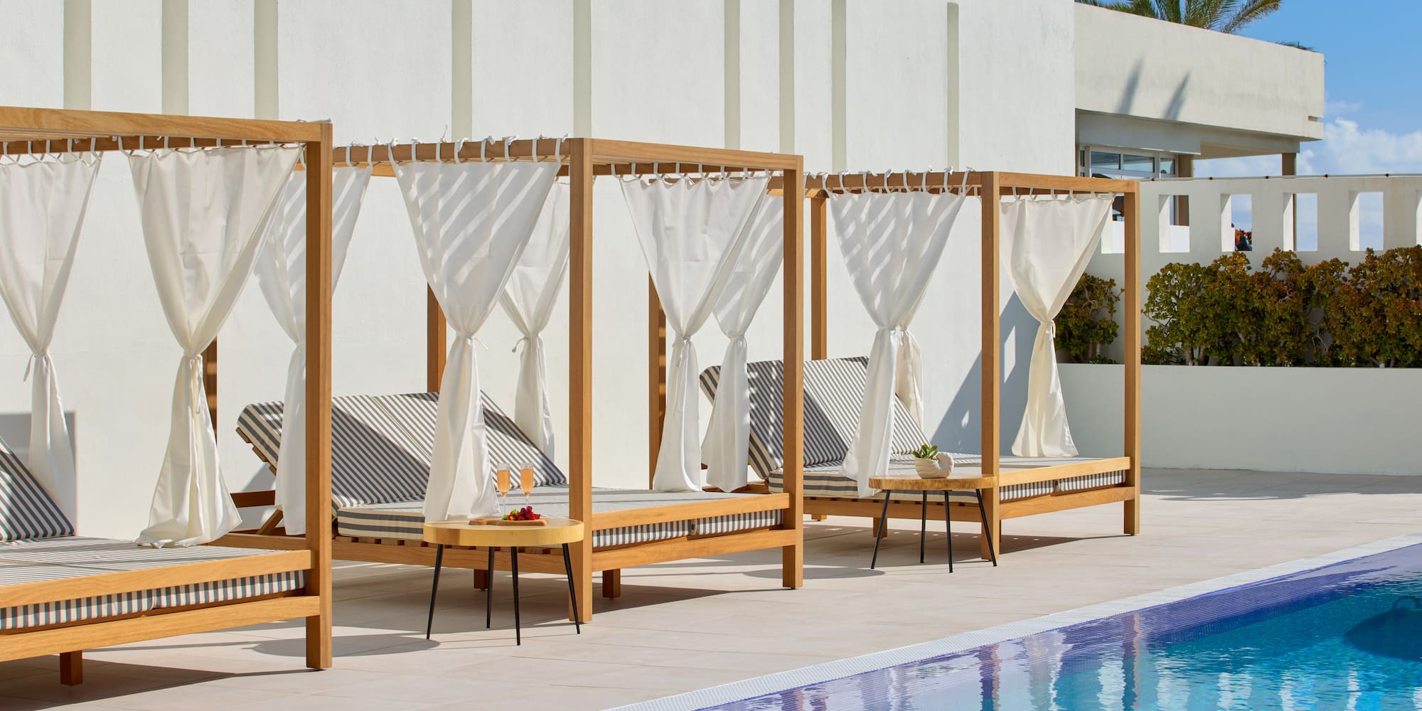 a pool with lounge chairs and a table