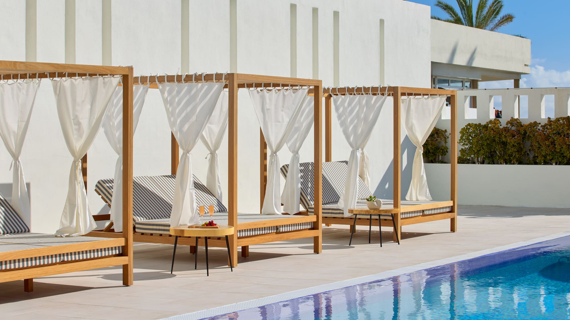 a pool with lounge chairs and a table