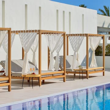 a pool with lounge chairs and a table