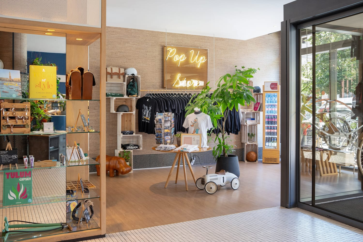 a store with a display of clothes and a sign