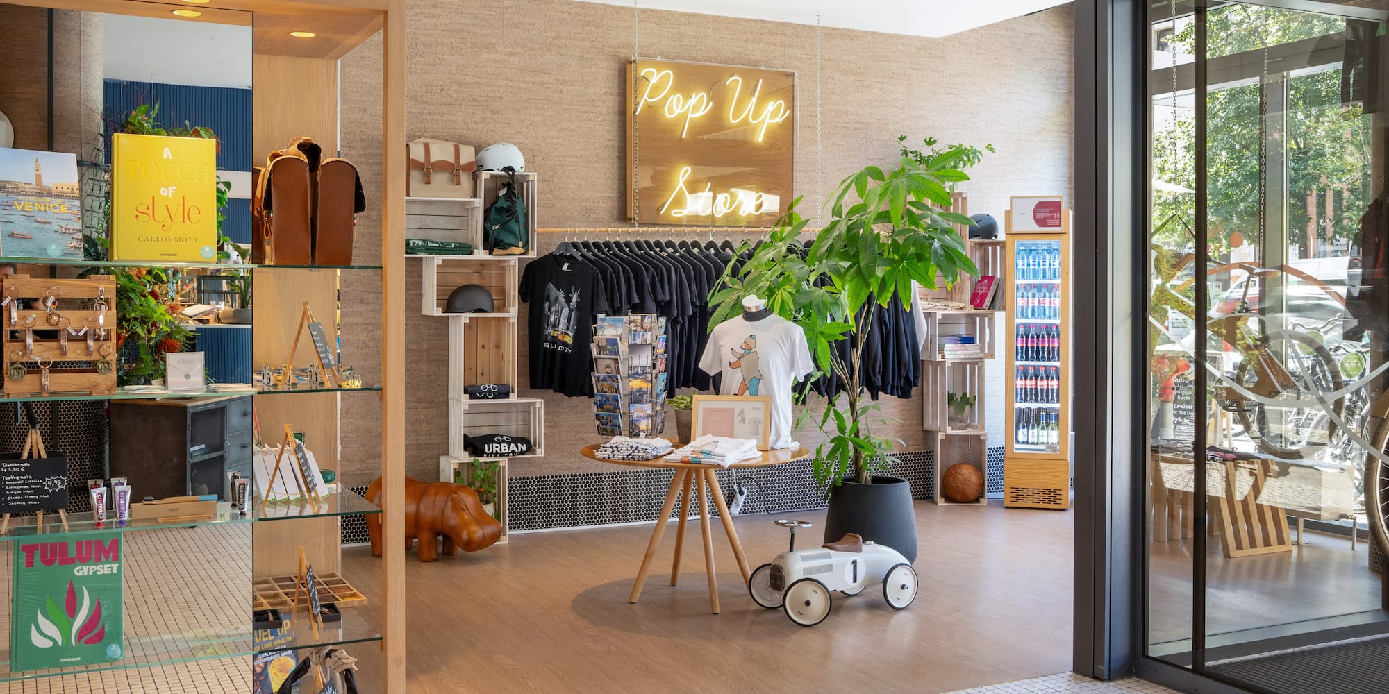 a store with a display of clothes and a sign