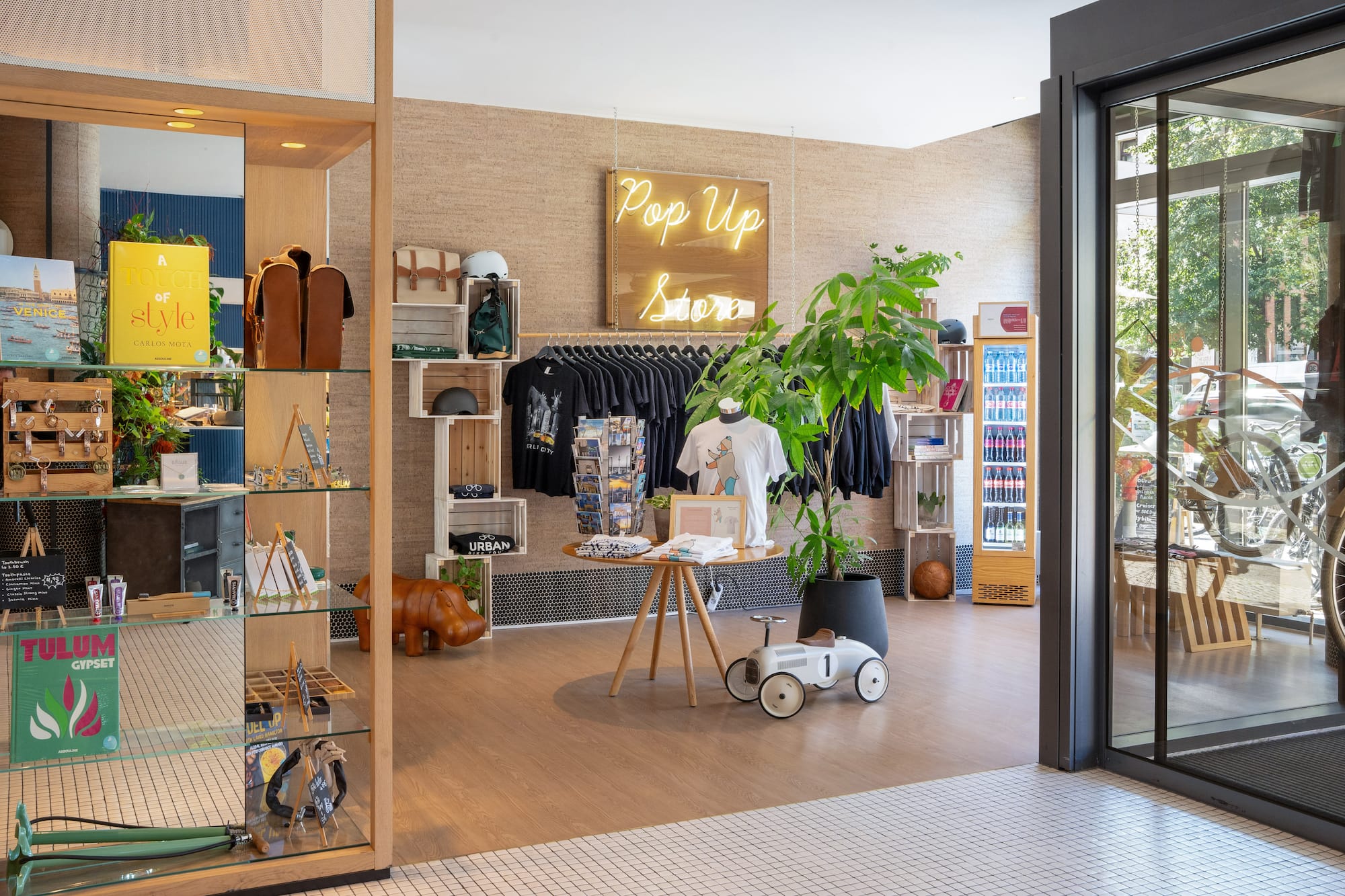 a store with a display of clothes and a sign