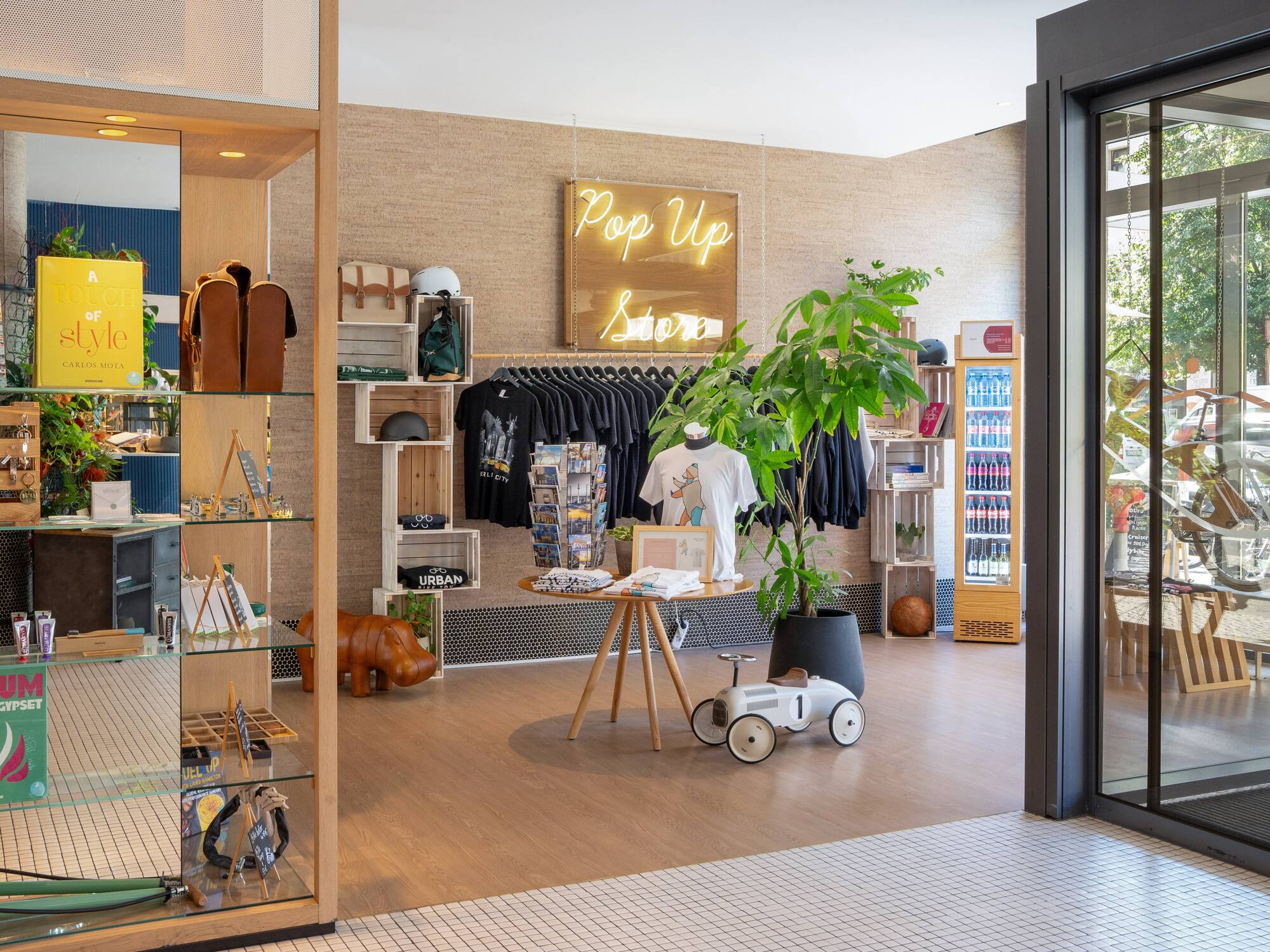 a store with a display of clothes and a sign