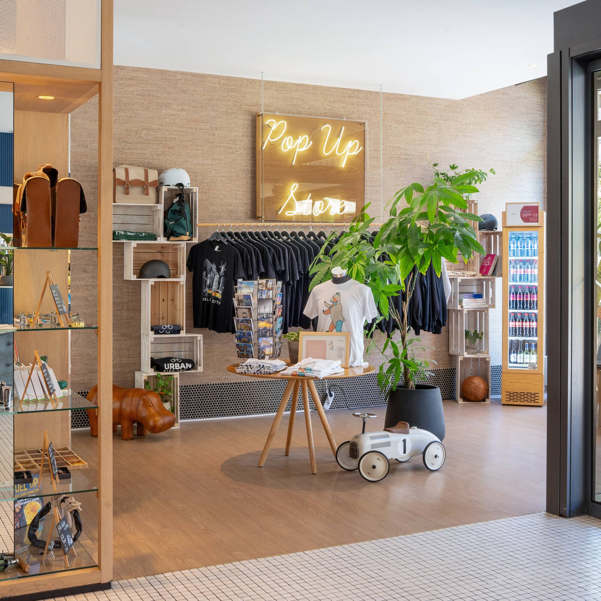 a store with a display of clothes and a sign