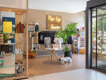 a store with a display of clothes and a sign